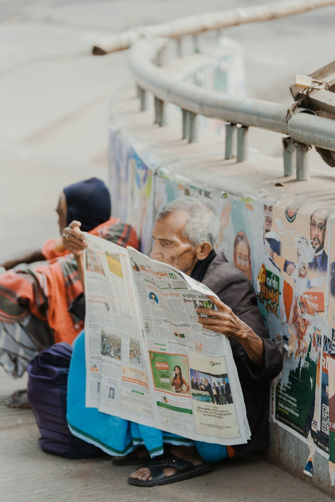 elderly couple reading newspaper