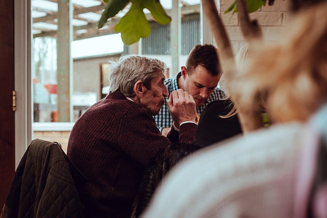 Croatian seniors gathered indoors at a community center chatting and smiling